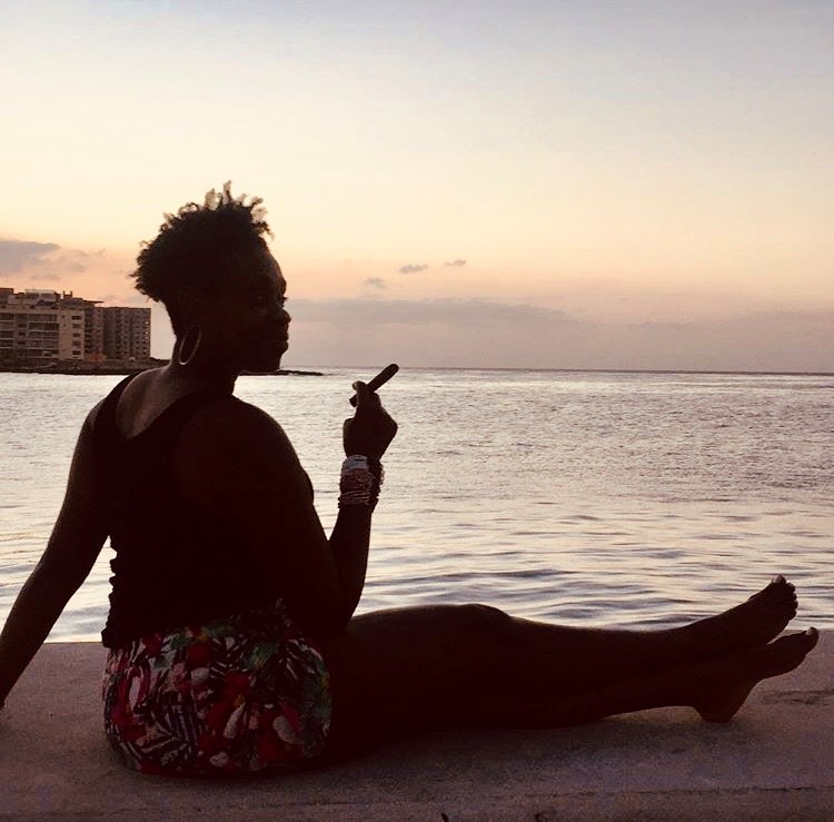 Lady Chin smoking a cigar on the Malecon in Havana, Cuba