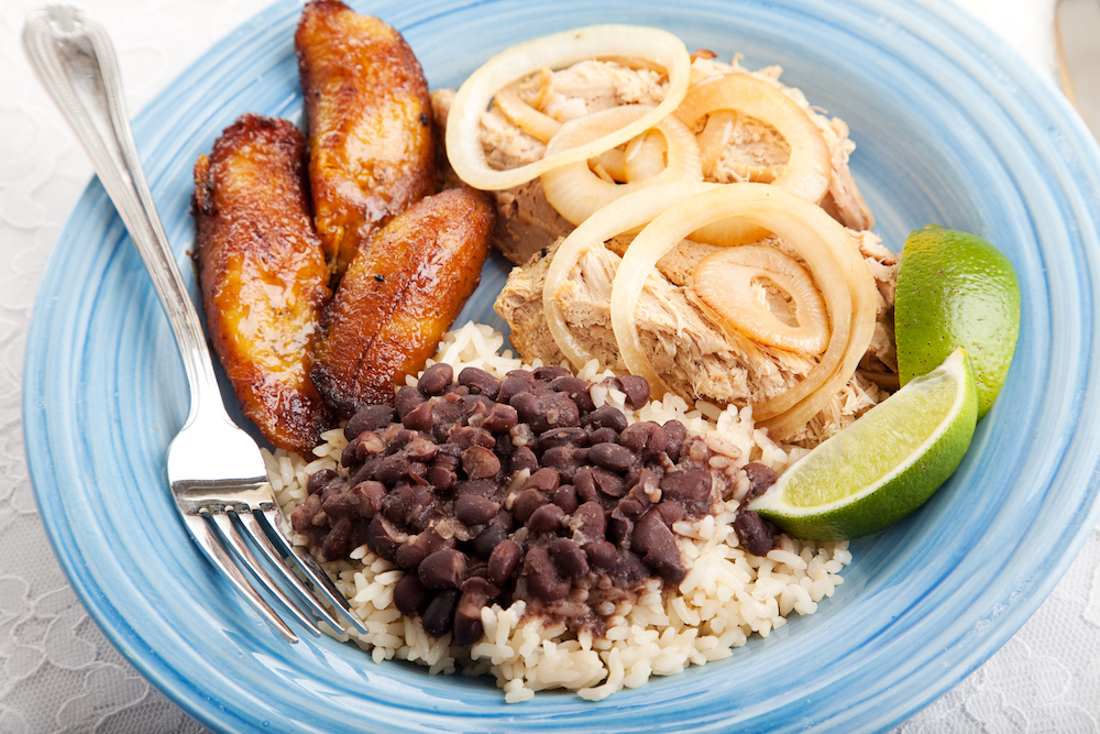 Traditional Cuban food, roast pork, black beans and rice and sweet plantains