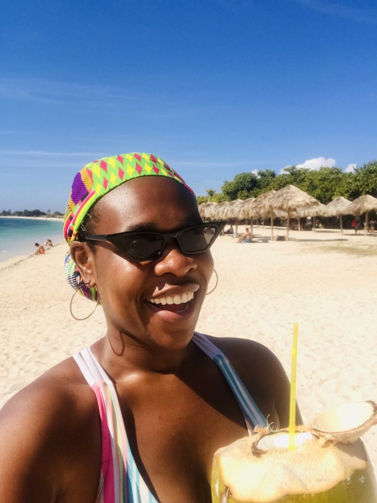 The Complete Trinidad, Cuba Travel Guide.  Lady Chin at Playa Ancon enjoying a fresh coconut