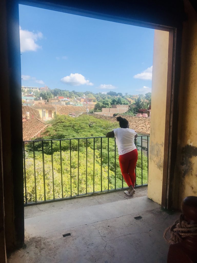 The Complete Trinidad, Cuba Travel Guide.  Lady posing with the spectacular views of Trinidad 