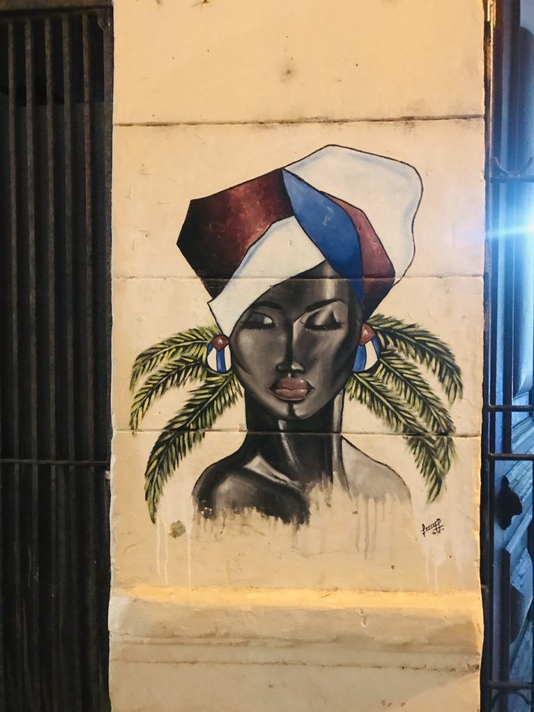 The Ultimate Cuba Bucket List: 101 Fun Things To Do in Cuba. Street art of a beautiful Cuban woman. 