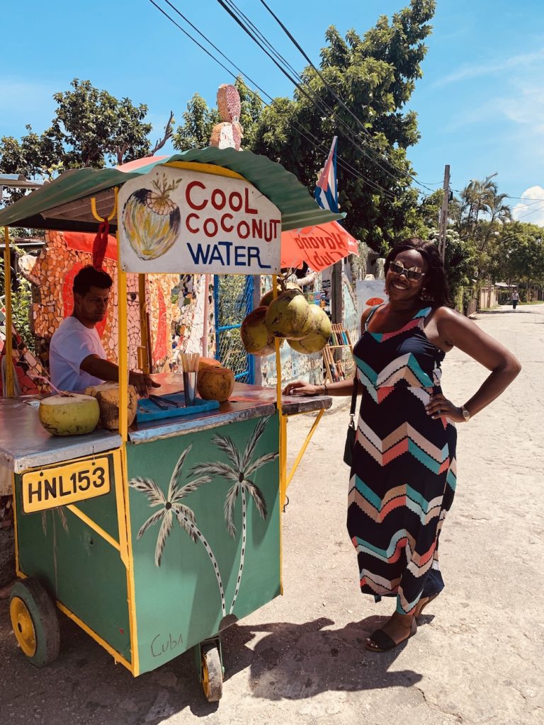 The Complete Packing List for Cuba: What To Bring To Cuba.  Lady Chin waiting for a fresh coconut water at Fusterlandia in Havana, Cuba.