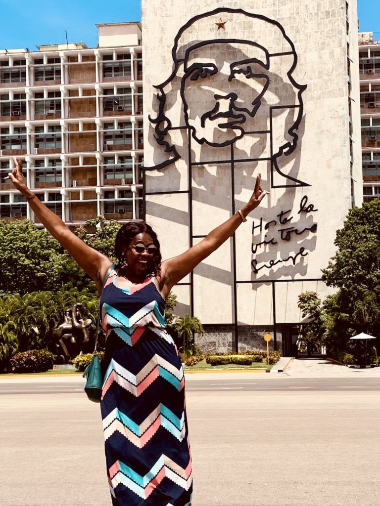 Cuba Bucket List: 10 Best Things To Do In Cuba.  Lady Chin with peace signs in front of the Plaza Revolucion in Vedado, Havana.