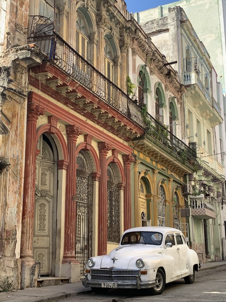 Classic car in front of Spanish-colonial house in Old Havana, Cuba.