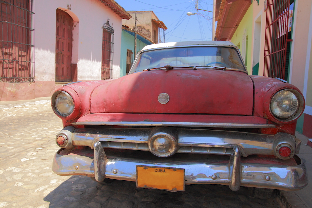 The Ultimate Cuba Travel Guide.  How to explore Trinidad in 3 days. Image shown: Classic car in Trinidad, Cuba.