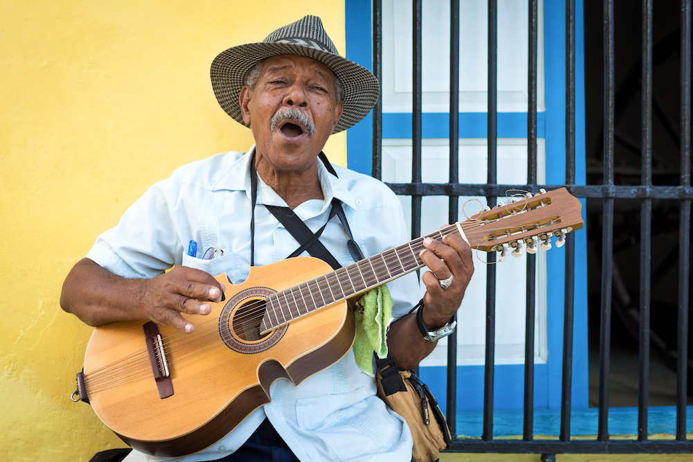 The Ultimate Cuba Travel Guide.  Musician playing traditional Cuban music in Old Havana, Cuba. 