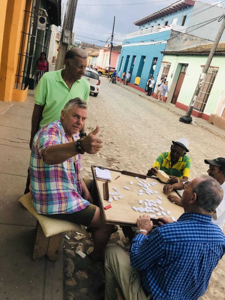 The Complete Trinidad, Cuba Travel Guide.  Men playing dominos on the street in Trinidad
