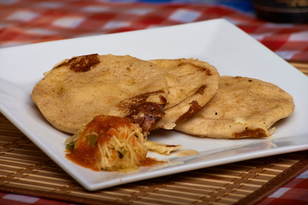 10 Delicious Foods To Try in Belize. Pupusas are El Salvadoran but staple food in Belize. Featured: bean and cheese pupusa. 