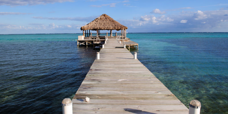 Ambergris Caye Travel Guide. Beach Deck with Palapa floating in the water