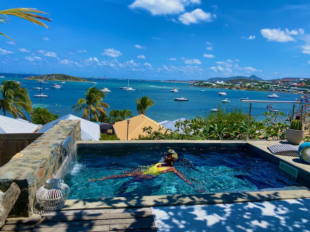 Lady Chin Swimming in a pool in Saint Martin overlooking the ocean. 