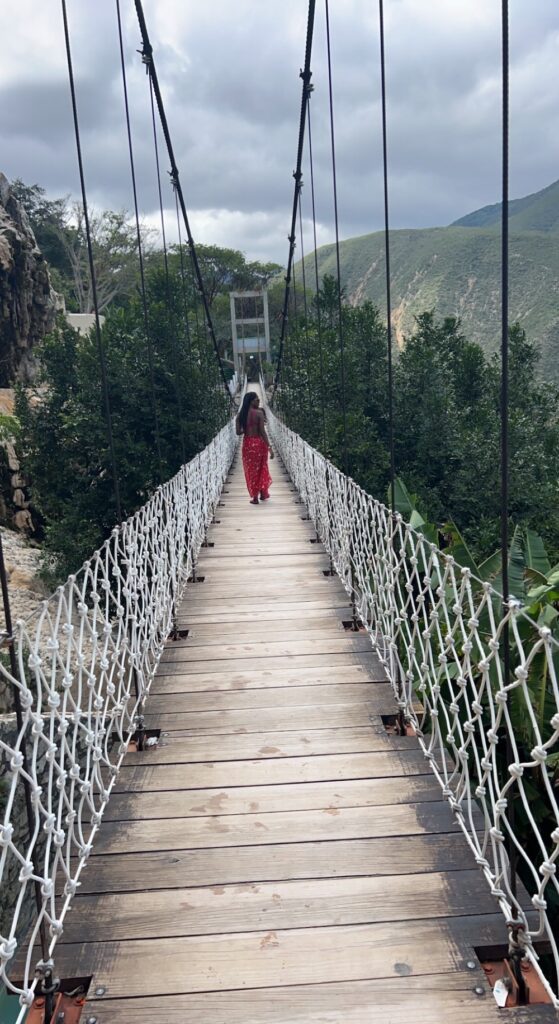 Imagine of lady crossing the suspension bridge at Grutas Tolantongo.