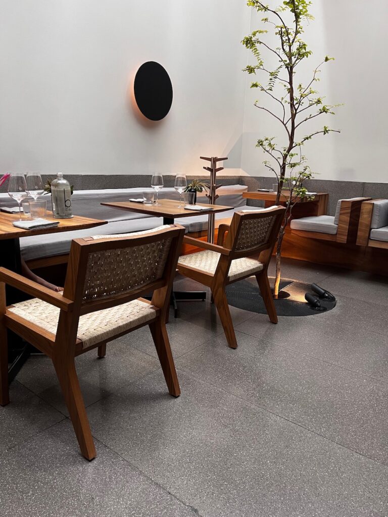 Image of table and chairs displayed beautifully inside the Pujol restaurant in Polanco, Mexico City. 