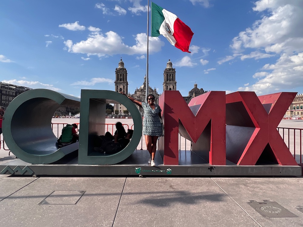 Imagine of Lady Chin in front of CDMX sign in Zócalo in Mexico City.  How to pack for a week in Mexico City in a carry-on: A guide for women. 