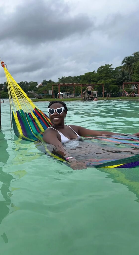 Image of Lady Chin in a hammock at Cocalitos Beach Club in Bacalar, Mexico.