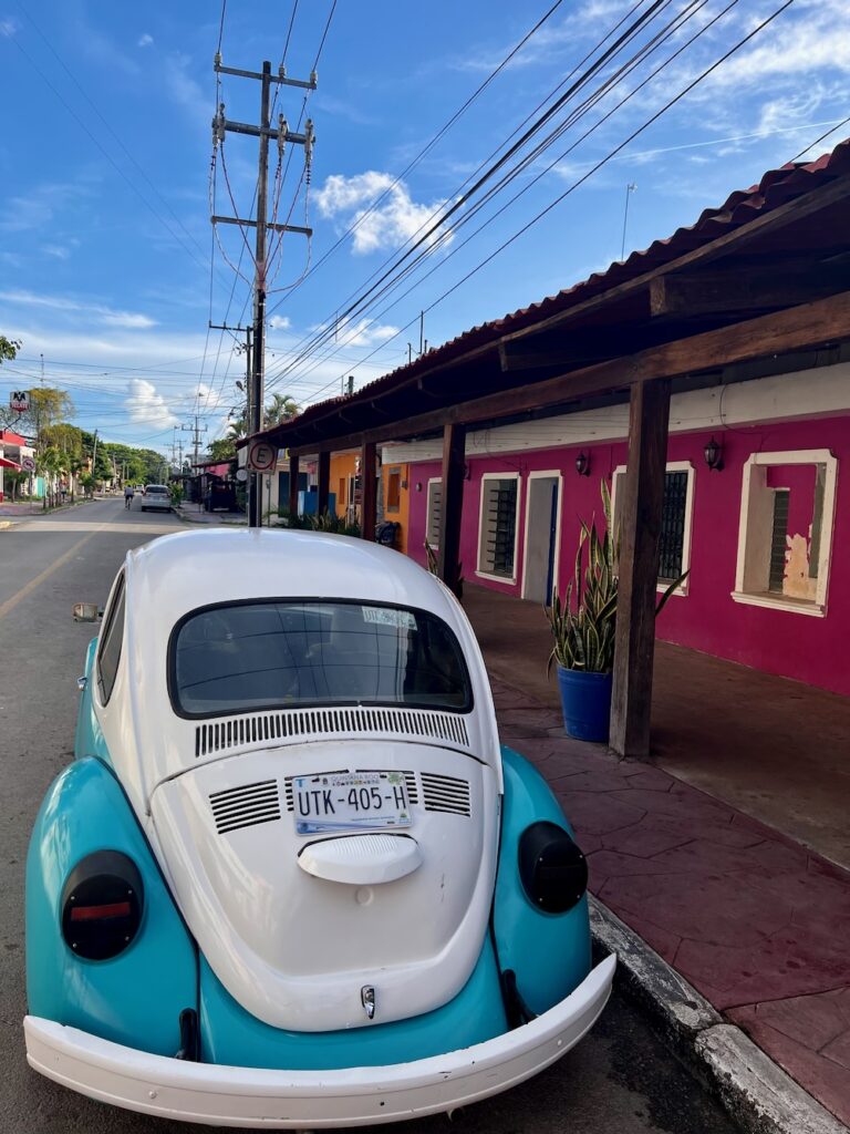 Blue and While beetle car in downtown Bacalar Lagoon, Mexico. 