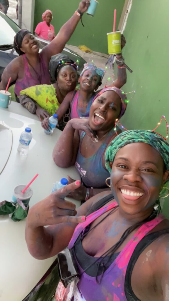 5 ladies covered in paint and powder at J'ourvert with red Antz at Trinidad Carnival.  Planning guide for Trinidad Carnival 2024.