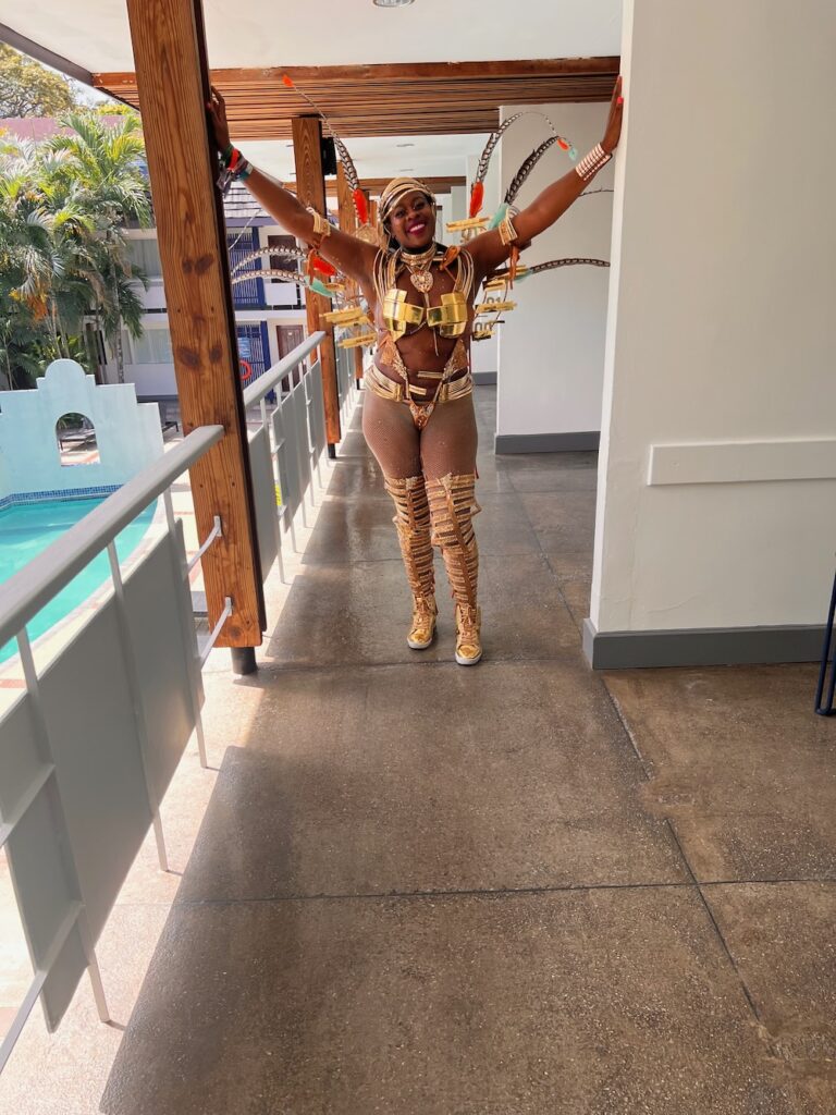 Black lady dressed in Caribbean costume for Trinidad Carnival.  Planning guide for Trinidad Carnival 2024.