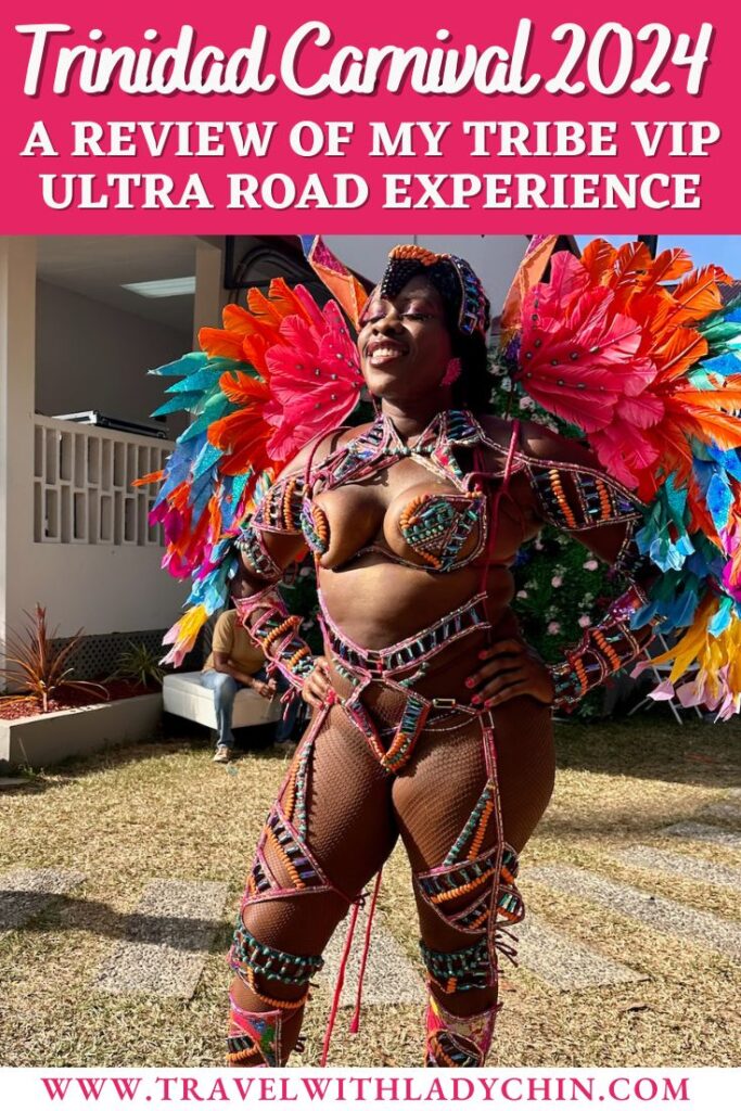 Pretty Black woman standing with her hands on her hips smiling with her eyes closed wearing a colorful costume with beads, sequins with pink, orange, blue, yellow, light pink feathers. 