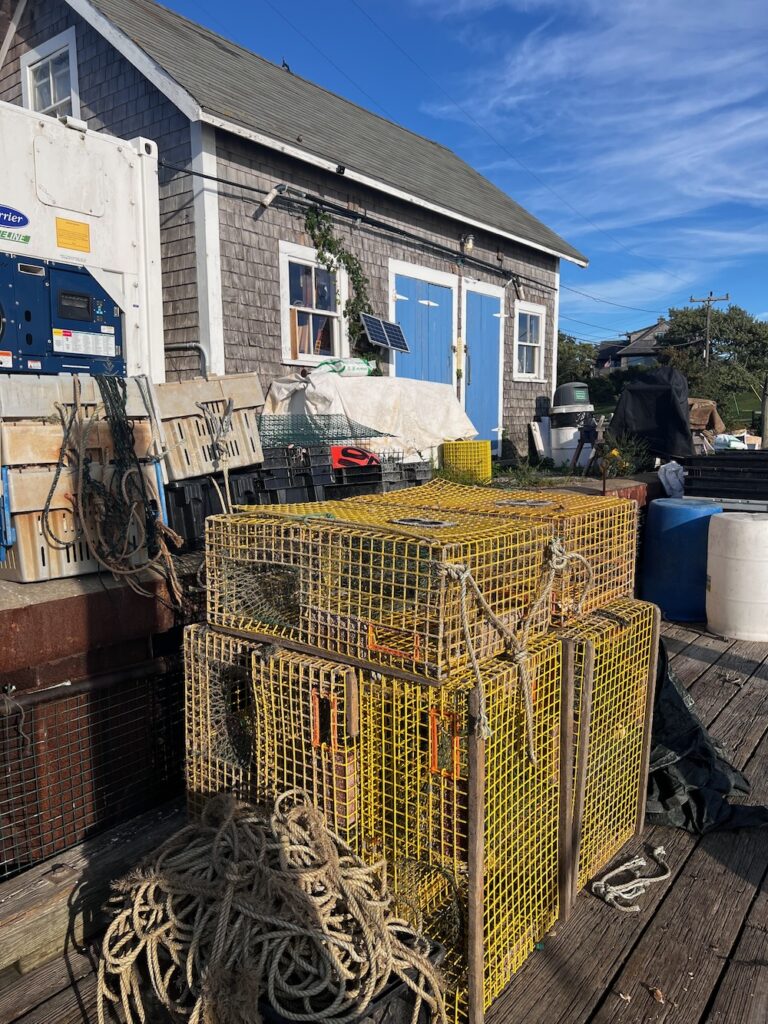 Yellow fishing crates sitting on harbor deck in Menemsha 