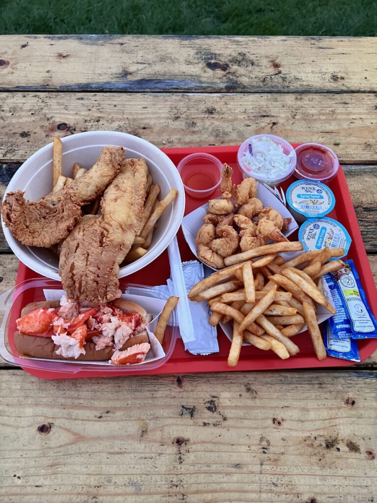 Fried fish, fried shrimp and french fry platter with lobster roll from Nancy's snack bar. 