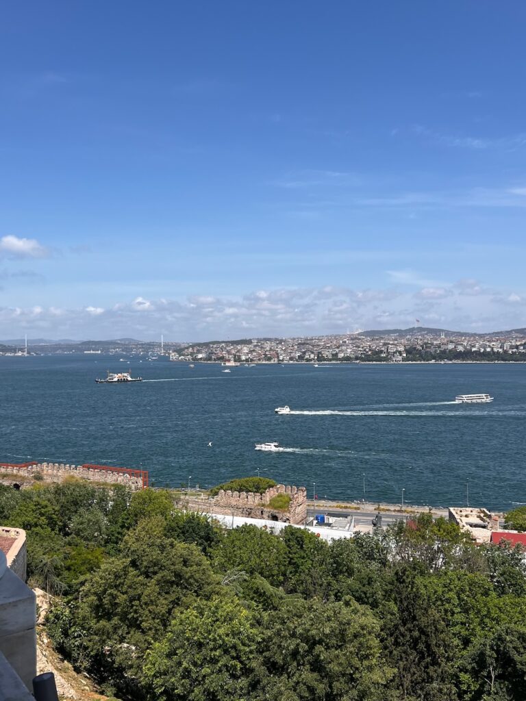 Sunny day and view of the Bosphorus Strait with boats going by in Istanbul. 